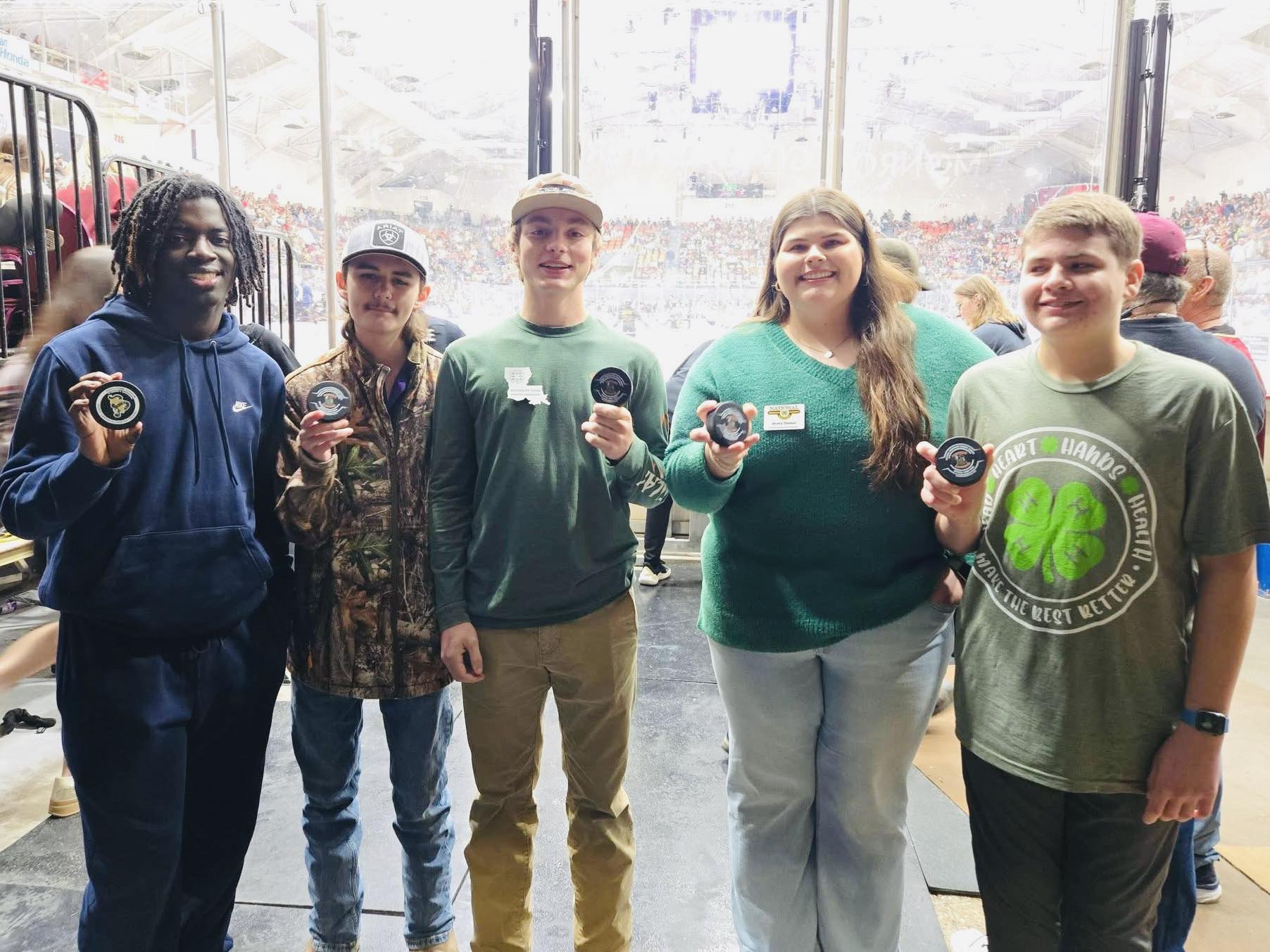Five teenagers posing for a picture.